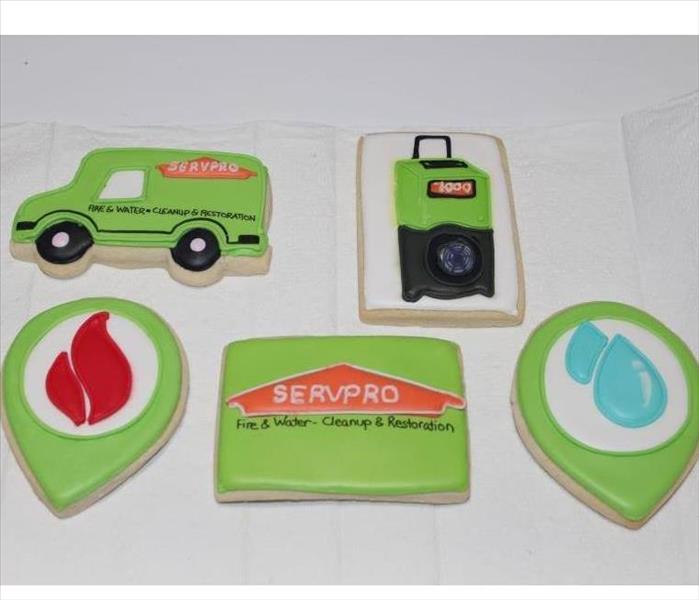 sugar cookies in the design of a dehumidifier, a SERVPRO van, a water drop, a fire logo, and the SERVPRO logo 