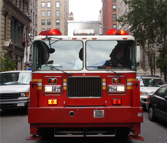 A fire truck is driving down a city street.