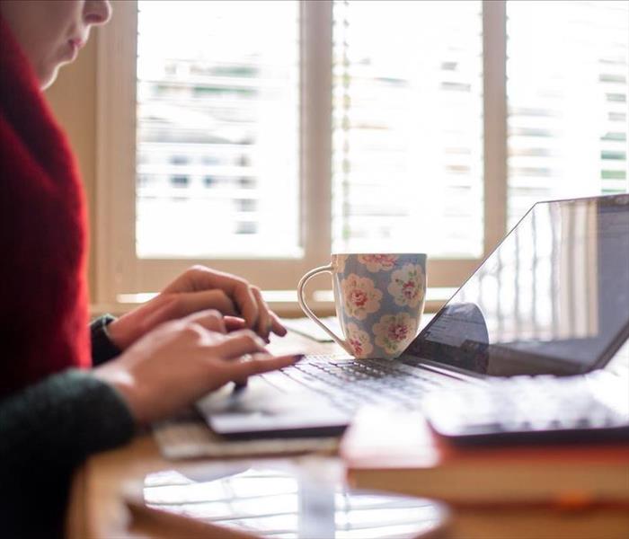 image of female working from home with their laptop open on a table