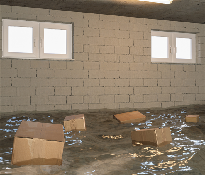 boxes floating in water in a flooded basement