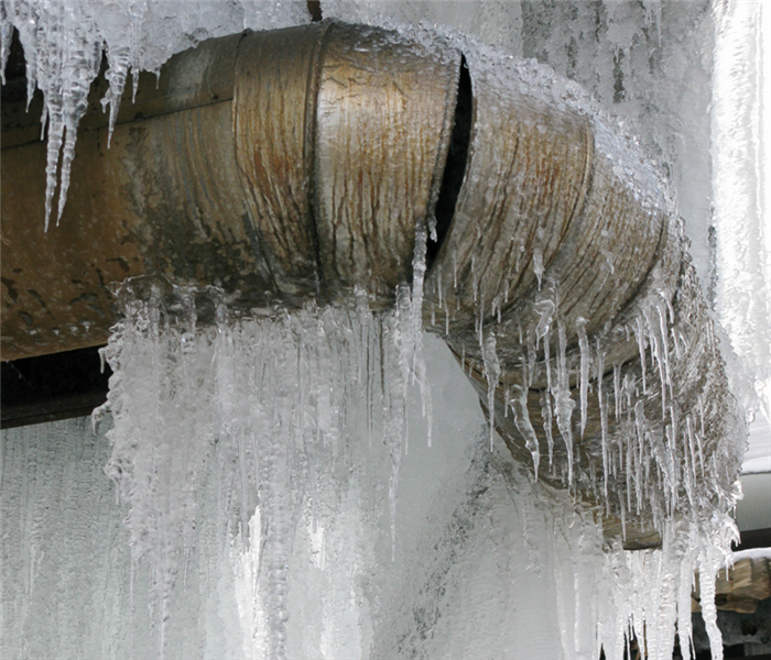 Close up of an exterior pipe that is frozen 